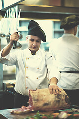 Image showing chef cutting big piece of beef