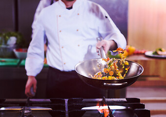 Image showing chef flipping vegetables in wok