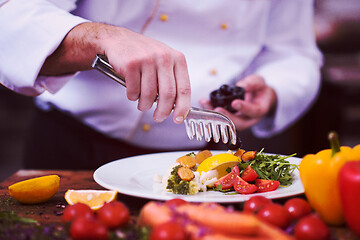 Image showing chef serving vegetable salad