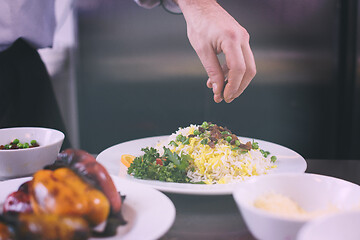 Image showing Chef hands serving vegetable risotto