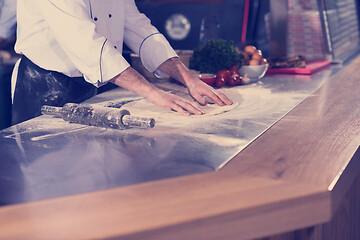 Image showing chef preparing dough for pizza