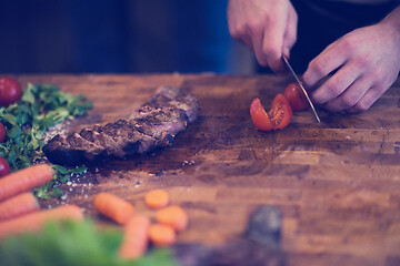 Image showing closeup of Chef hands preparing beef steak