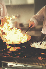 Image showing Chef doing flambe on food