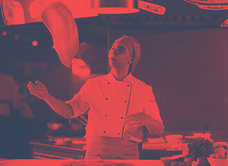 Image showing chef throwing up pizza dough