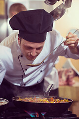 Image showing chef tasting food with spoon