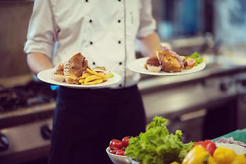 Image showing Chef showing dishes of tasty meals