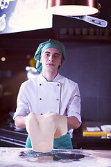 Image showing chef throwing up pizza dough