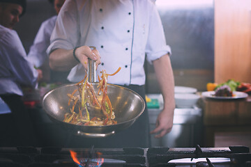 Image showing chef flipping vegetables in wok