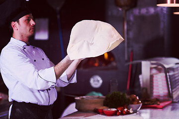 Image showing chef throwing up pizza dough