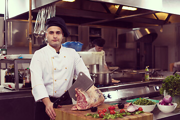 Image showing chef cutting big piece of beef