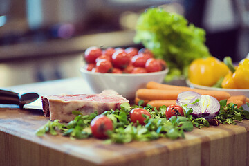 Image showing Juicy slice of raw steak on wooden table