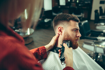 Image showing Client during beard shaving in barber shop