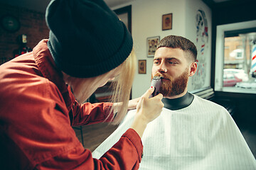 Image showing Client during beard shaving in barber shop