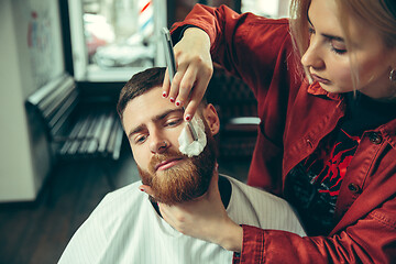 Image showing Client during beard shaving in barber shop