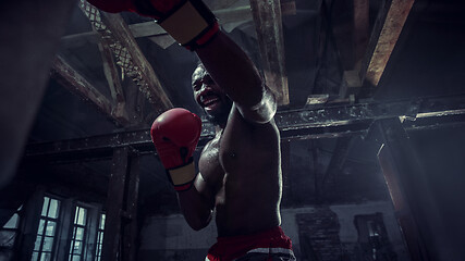 Image showing Hand of boxer over black background. Strength, attack and motion concept