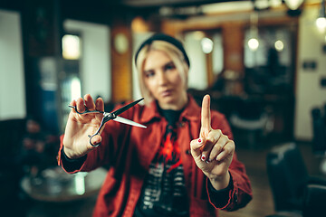 Image showing Female barber in barber shop