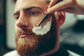 Image showing Client during beard shaving in barber shop