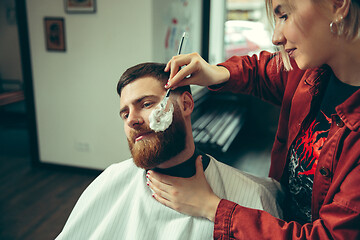 Image showing Client during beard shaving in barber shop