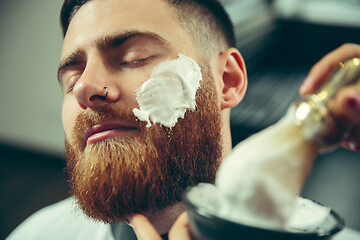 Image showing Client during beard shaving in barber shop
