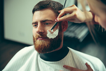 Image showing Client during beard shaving in barber shop