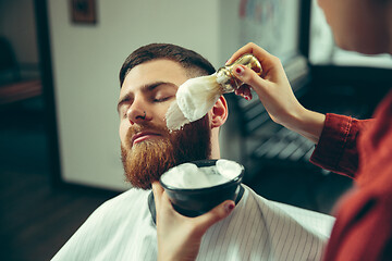 Image showing Client during beard shaving in barber shop