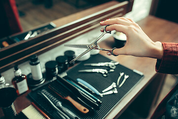 Image showing Female barber in barber shop