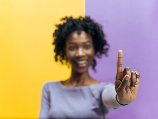 Image showing Woman\'s hand with finger on blue background