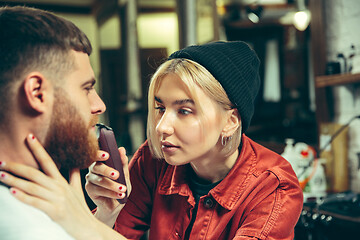 Image showing Client during beard shaving in barber shop