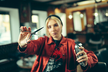 Image showing Female barber in barber shop