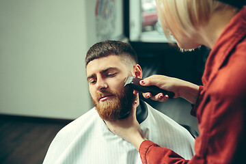 Image showing Client during beard shaving in barber shop