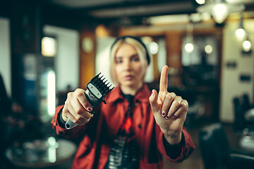 Image showing Female barber in barber shop