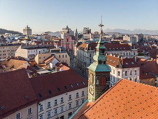 Image showing Scenic panoramic aerial drone view of rooftops of medieval city center, town hall and cathedral church in Ljubljana, capital of Slovenia, at sunset