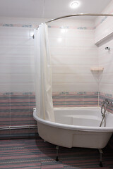 Image showing View of the acrylic bathtub in the bathroom interior