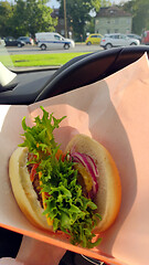 Image showing Somebody eating gourmet burger in car