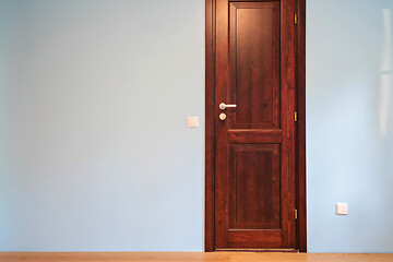 Image showing Frontal view to the wooden door in home interior