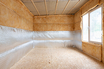 Image showing Interior of a country house, a heat-insulating layer of reflective polyethylene foam laminated with lavsan when insulating a house