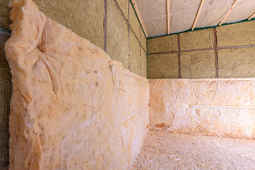 Image showing Combination of roll and thermal insulation with plates in a country wooden house