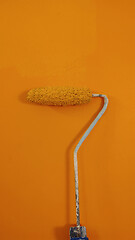 Image showing A paint roller against the wall