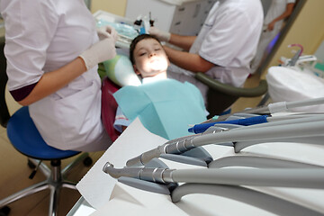 Image showing Dentist examining boy mouth