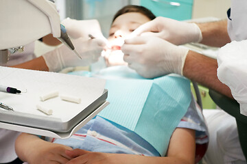 Image showing Dentist examining boy mouth