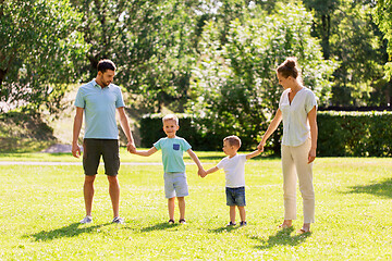 Image showing happy family holding hands at summer park