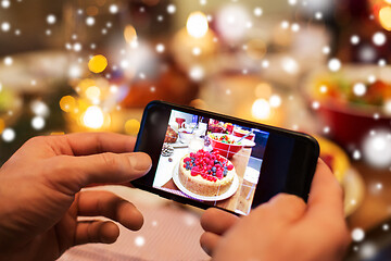 Image showing hands photographing food at christmas dinner