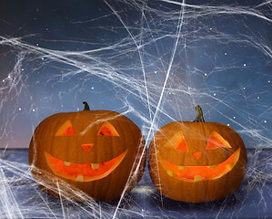 Image showing two pumpkins or jack o lanterns and spiderweb