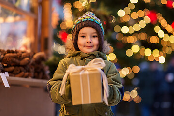 Image showing happy boy with gift box at christmas market