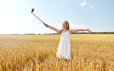 Image showing happy young girl taking selfie by smartphone