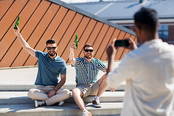 Image showing man photographing friends drinking beer on street