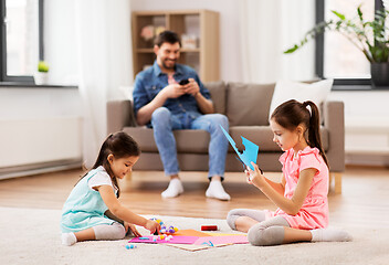 Image showing happy sisters doing arts and crafts at home