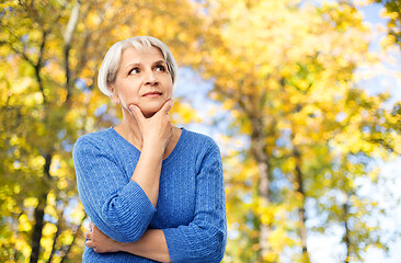 Image showing portrait of senior woman thinking in autumn park