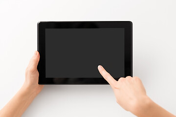 Image showing close up of hands with black tablet computer