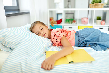 Image showing little girl with book sleeping in her room at home